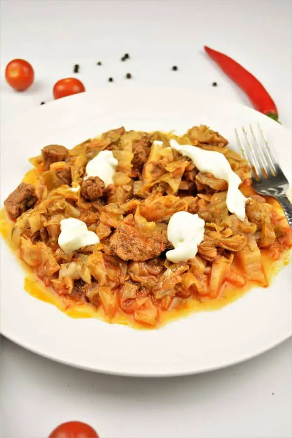 Beef and Cabbage Stew Recipe-Served on Plate With Sour Cream on the Top