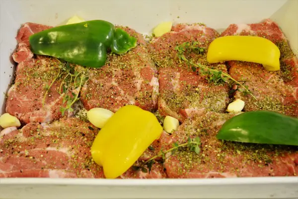 Easy Oven Baked Pork Steak Recipe-Cut Bell Peppers on Seasoned Pork Neck Slices