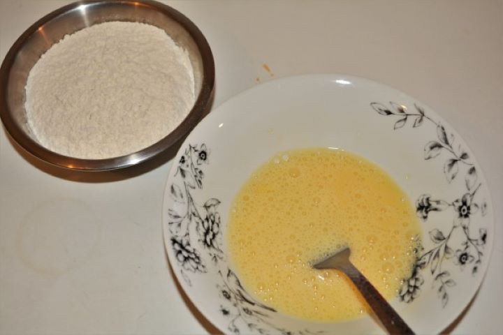 Beaten Eggs and Wheat Flour on the Table