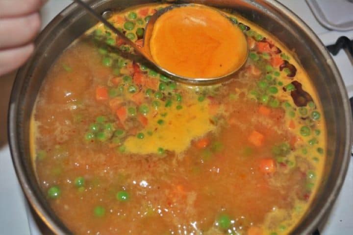 Remove the Foam From the Hungarian Green Pea Soup With Ladle