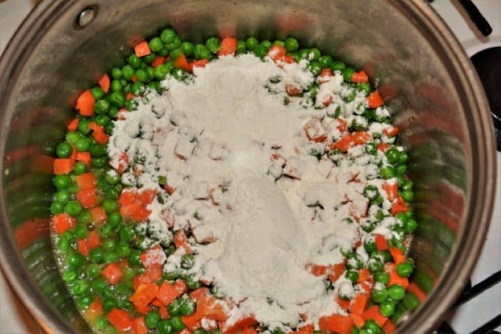 Wheat Flour on Frying Frozen Pea and Carrots in the Pot