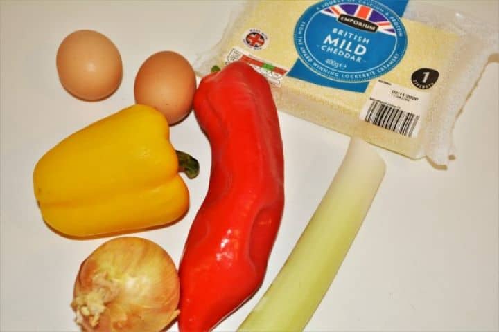 Eggs, Onion, Leek, Peppers and Cheddar Cheese on the Table
