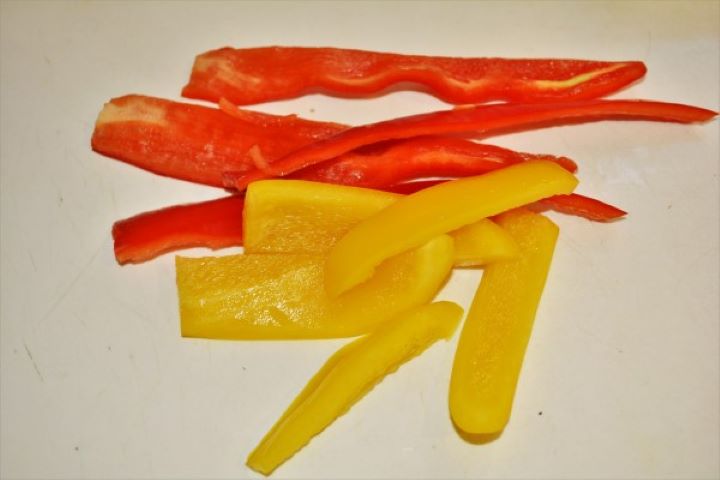 Peppers Cut Into Strips on Chopping Board