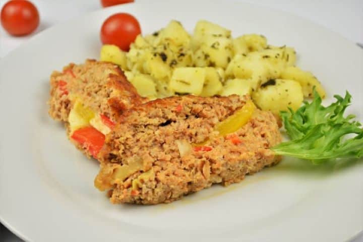 Stuffed Pork Meatloaf Served on White Plate With Boiled Potatoes