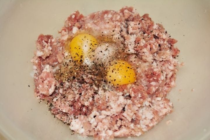 Two Whole Eggs on the Pork Mince Seasoned With Salt and Ground Pepper