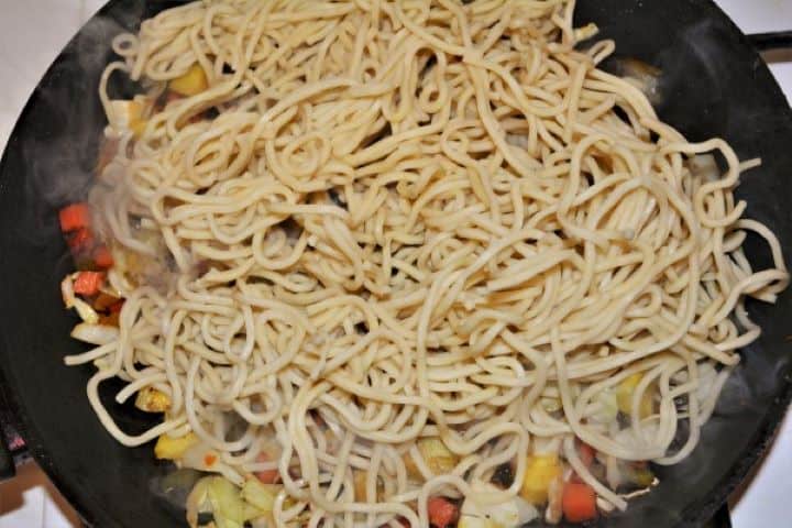 King Prawn Noodles Recipe - Egg Noodles on Frying Vegetables Egg Noodles on Frying Vegetables in the Pan