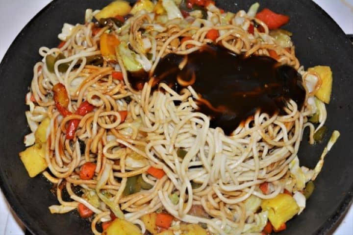 King Prawn Noodles Recipe - Pour the Teriyaki and Soy Sauces on the Frying Noodles Adding egg noodles and teriyaki soy sauce glaze to the stir fry vegetable mix