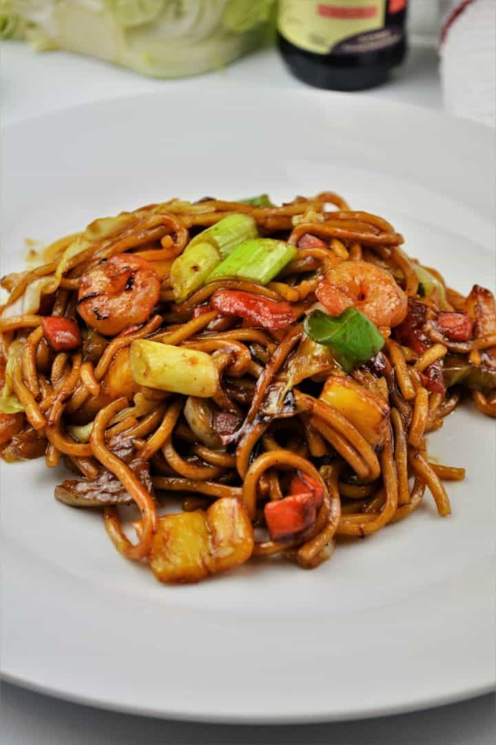 15-minute king prawn noodles recipe with teriyaki sauce and egg noodles on a white plate