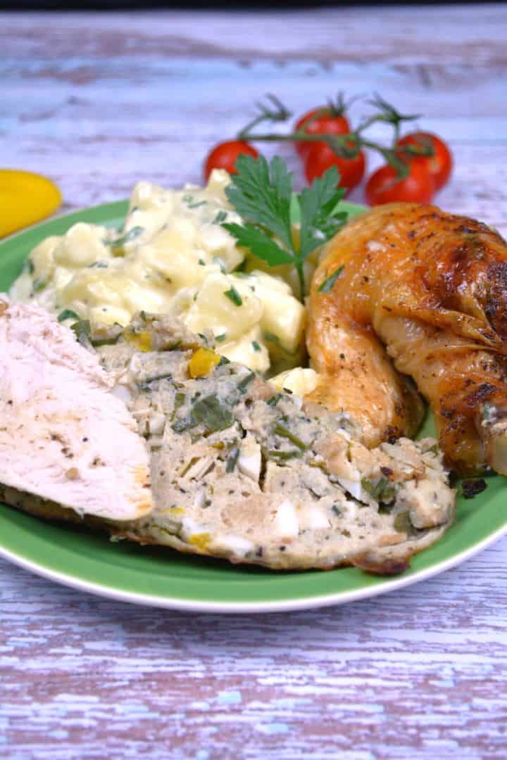 A golden-brown crispy baked stuffed whole chicken on a serving platter, sliced to reveal the traditional Transylvanian bread stuffing.
