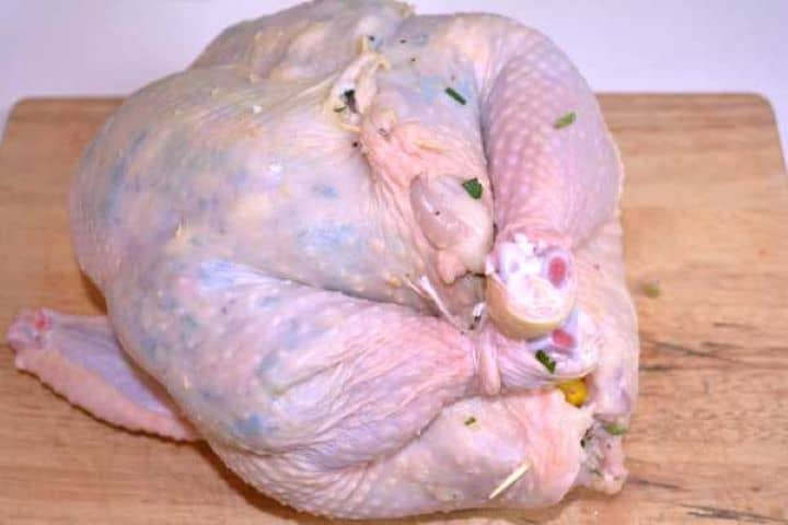 Baked Stuffed Whole Chicken Recipe-Stuffed Chicken Stuffed Raw Chicken Before Cooking on the Table