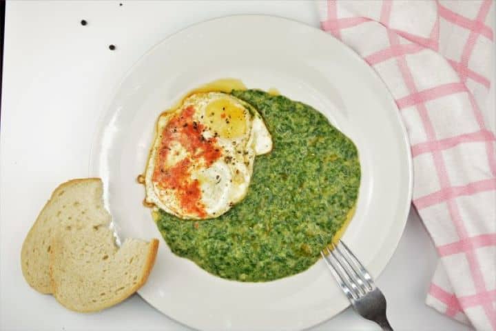 Quick Creamed Spinach Recipe Served on Plate With Fried Egg