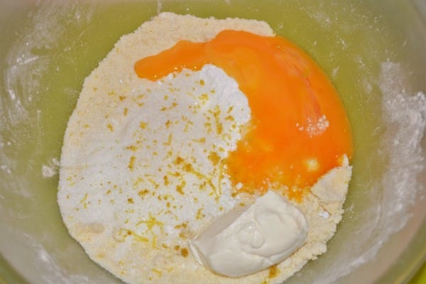 Traditional Baked Cheesecake Recipe-Mixed Wheat Flour and Butter, Egg Yolks, Sugar and Sour Cream in the Mixing Bowl