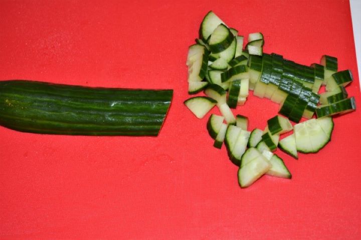 Simple Tuna And Pasta Salad Recipe - Cucumber Cut in Cubes Cucumber Cut in Cubes on the Chopping Board
