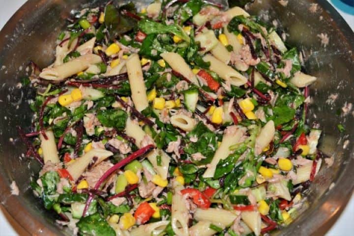 Simple Tuna And Pasta Salad Recipe - Ready to Serve A vibrant bowl of easy tuna pasta salad without mayo, featuring penne, sweetcorn, diced cucumber, and crisp bistro salad mix.