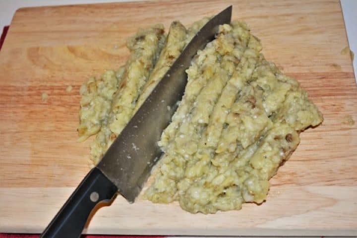 Grilled Eggplant Dip Recipe-Chopping the Grilled Eggplants Finely chopping roasted aubergine on a wooden board for Romanian eggplant spread.