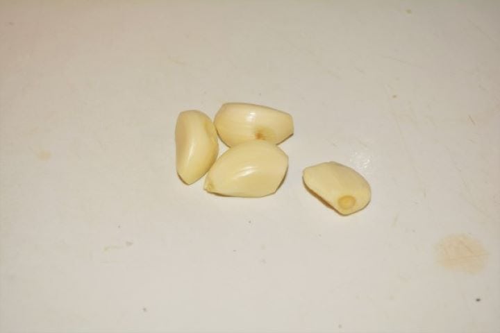 Easy Homemade Refried Beans Recipe-Cleaned Garlic Cloves Cleaned Garlic Cloves on the Chopping Board