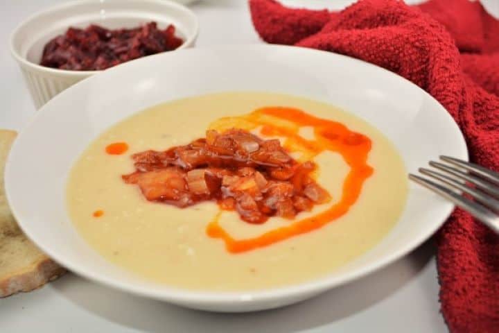 Easy Homemade Refried Beans Recipe-Served With Fried Onions Creamy Fasole Bătută white bean puree with a deep well of vibrant red paprika oil and soft onions.