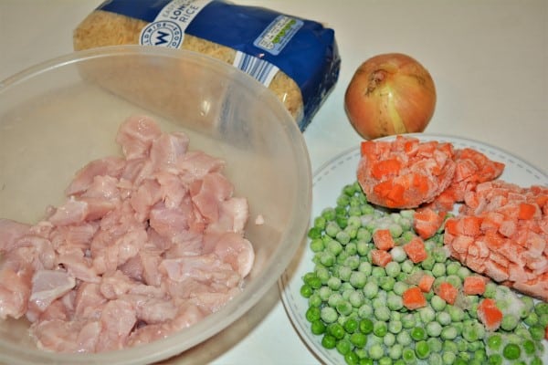 Simple Turkey Fried Rice Recipe-Turkey Breasts Cut in Cubes in the Bowl, Rice, Onion and Frozen Carrots and Peas