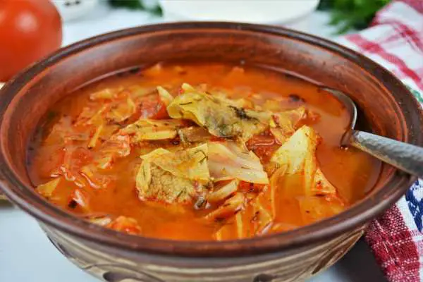 Cabbage Soup With Pork Meat-Served in Bowl With Fresh Bread