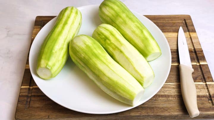 Grated Summer Squash Stew Recipe-Peeling the Summer Squash Four Peeled Summer Squash on the Plate