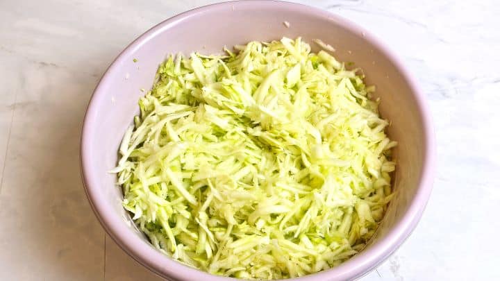 Grated Summer Squash Stew Recipe-Grating the Peeled Summer Squash Grated Summer Squash in the Bowl