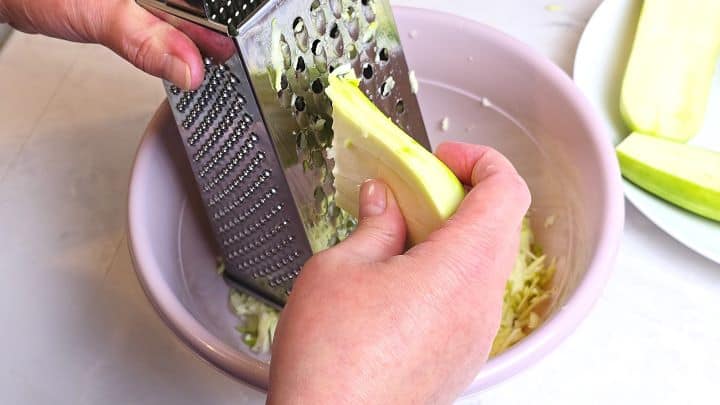 Grated Summer Squash Stew Recipe-Peeled Summer Squash Cut in Two Grating the Squash in the Bowl
