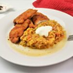Grated Summer Squash Stew Recipe-Served on Plate With Soured Cream With Beaded Pork Chops