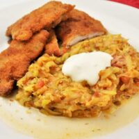 Grated Summer Squash Stew Recipe-Served on Plate With Soured Cream With Beaded Pork Chops