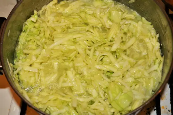 Grated Summer Squash Stew Recipe-Simmering Grated Summer Squash With Water in the Pot