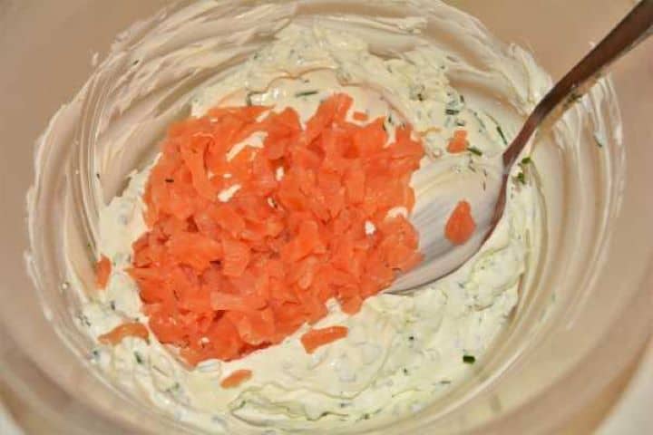 Best Smoked Salmon Cream Cheese Recipe-Chopped Smoked Salmon on the Cream Cheese in the Bowl Gently folding diced smoked salmon and fresh lemon juice into the herbed cream cheese mixture with a spoon.