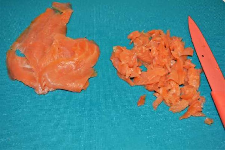 Best Smoked Salmon Cream Cheese Recipe-Chopping the Smoked Salmon Finely dicing cold-smoked salmon slices on a cutting board.