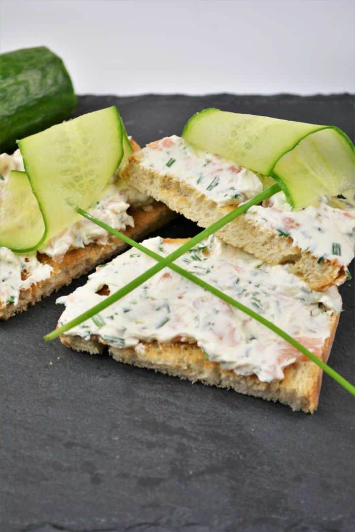 Best Smoked Salmon Cream Cheese Recipe-Served on Toast With Cucumber Thin Slices Elegant party appetizer toast topped with a savory smoked salmon cream cheese spread and crisp cucumber slices.