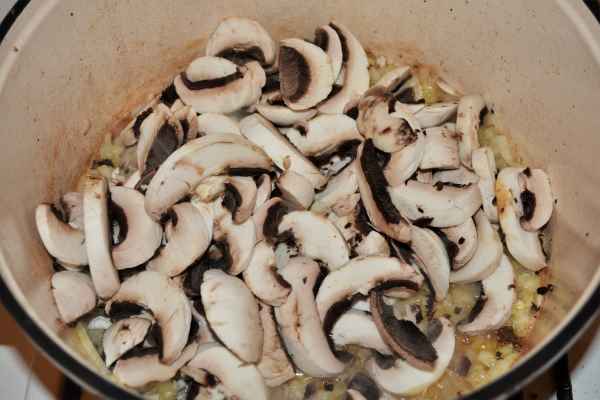Best Homemade Beef Stroganoff Recipe-Sliced Mushrooms Over Fried Onions in the Pot
