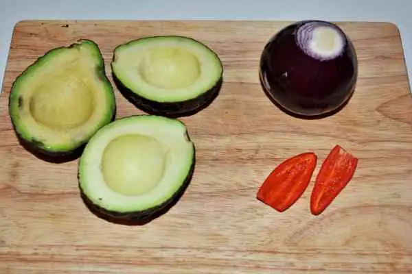 Best Homemade Guacamole Recipe-Cleaned Onion, Chilli Pepper and Avocados Cut in Two