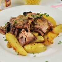 Braised Pork Knuckle Recipe-Served On Plate With Baked Potatoes