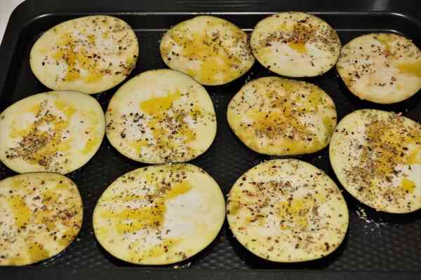 Mediterranean Roasted Eggplant Recipe-Slices of Eggplant Seasoned and Sprinkled with Oil in the Baking Tray