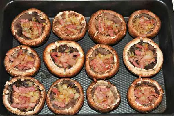 Stuffed Mushrooms With Cheese and Bacon-Portobello Mushrooms in Baking Tray Stuffed With Fried Bacon and Onion