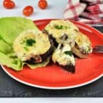 Stuffed Mushrooms With Cheese and Bacon-Served on Red Plate With Lettuce Leave