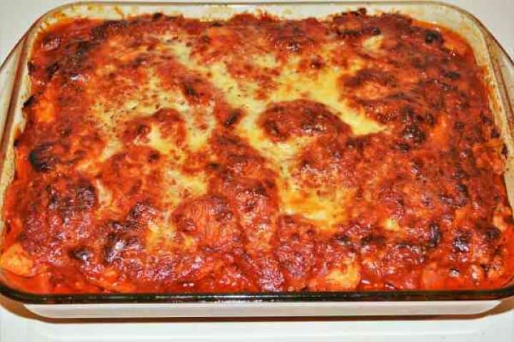 Easy Potato Moussaka Recipe-Baked and Ready to Serve Golden-brown baked potato moussaka in a glass casserole dish fresh from the oven.