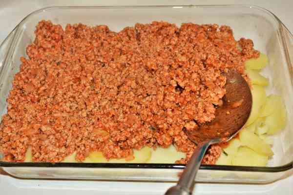 Easy Potato Moussaka Recipe-Fried Pork Mince on the Sliced Potatoes in the Baking Tray