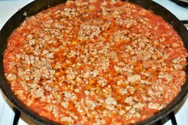 Easy Potato Moussaka Recipe-Fried and Seasoned Pork Mince in the Pan Thick, seasoned minced pork and tomato sauce simmering in the frying pan.