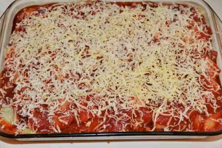 Easy Potato Moussaka Recipe-Grated Cheddar on the Top of the Dish Grated Cheddar and Grana Padano cheese scattered over the top of the moussaka.