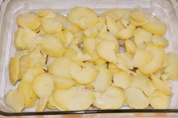 Easy Potato Moussaka Recipe-Sliced Potatoes on Bottom of Baking Tray