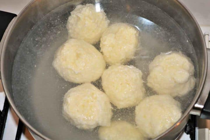 Best Cottage Cheese Dumplings-Boiling Cheese Balls in the Pot Hand-rolled cottage cheese dumplings gently simmering in a pot of hot water.