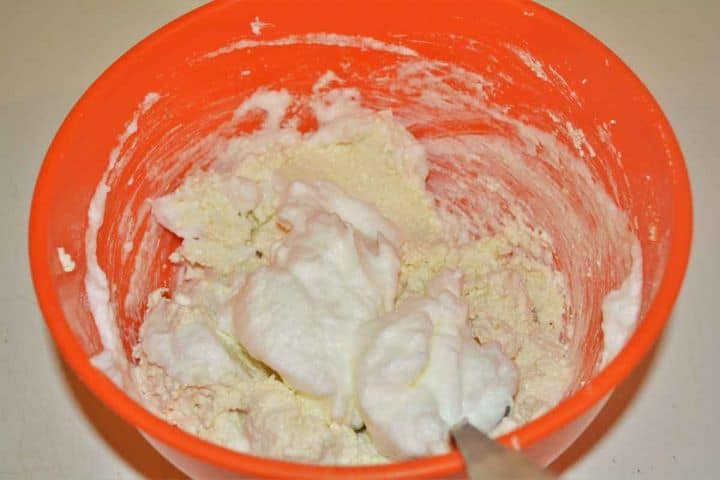 Best Cottage Cheese Dumplings-Mixing Cheese Paste With Egg White Foam Gently folding whipped egg whites into the cottage cheese dumpling mixture with a spoon.