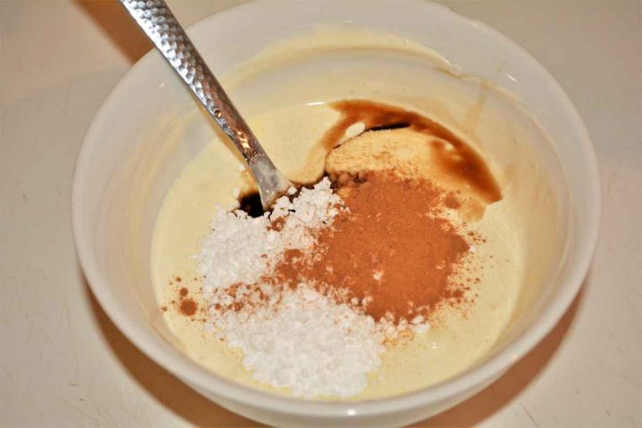 Best Cottage Cheese Dumplings-Mixing Creme Fresh, Icing Sugar, Cinnamon Powder and Vanilla Essence Whisking sour cream, icing sugar, vanilla extract, and cinnamon together in a small bowl.