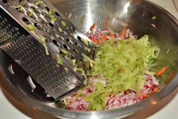 Mediterranean Cabbage Salad Recipe-Grated Cucumber on the Radish and Carrots in the Bowl
