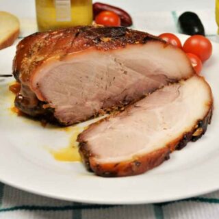 Slow-Cooked Pork Shoulder in the Oven-Sliced and Served on Plate With Mustard and Bread