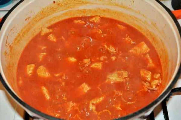 Turkey Cabbage Stew Recipe-Simmering Turkey Stew Braising the cubed turkey meat in red paprika broth in a pot.