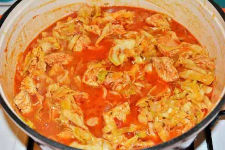 Turkey Cabbage Stew Recipe-Simmering Turkey and Cabbage Stew in the Pot Scattering finely chopped fresh dill into the simmering turkey cabbage stew.